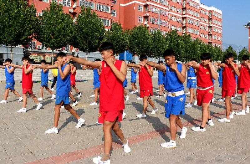 Students execute a traditional salute on the mats, marking the start of the Shaolin Kung fu Training Schedule.