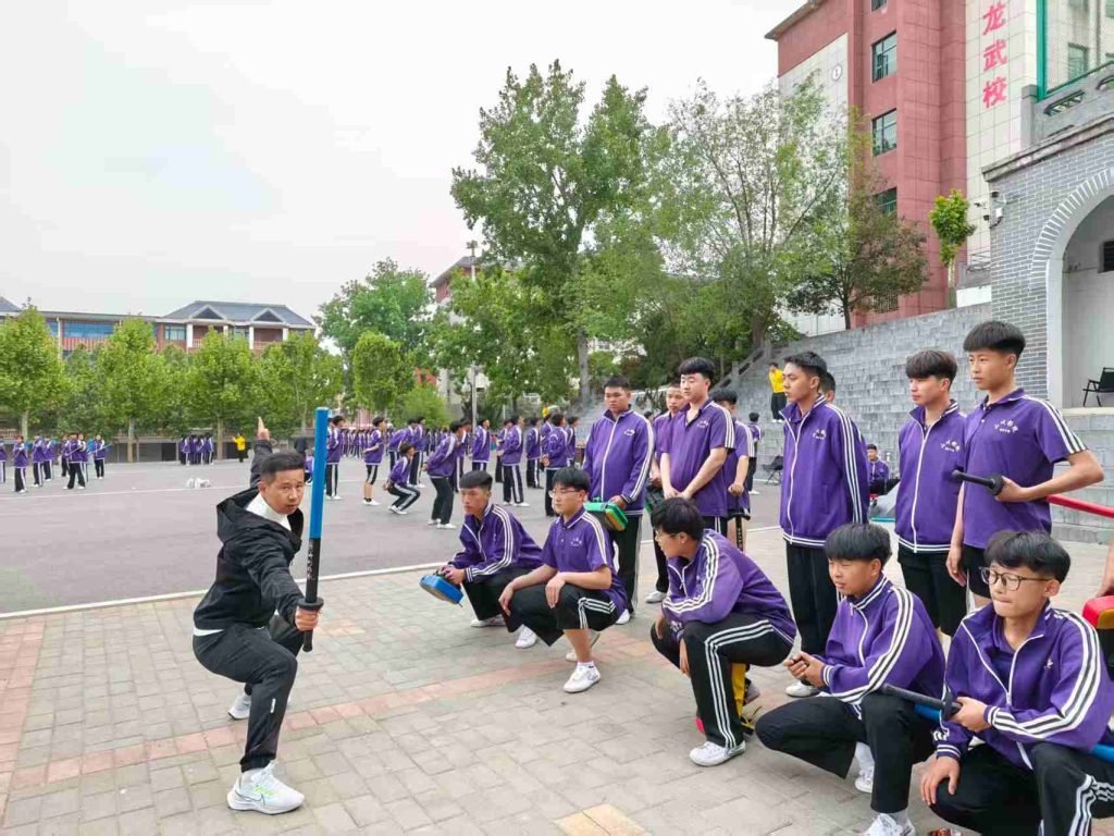 image shows shaolin kung fu coach wu peng performing with a weapon