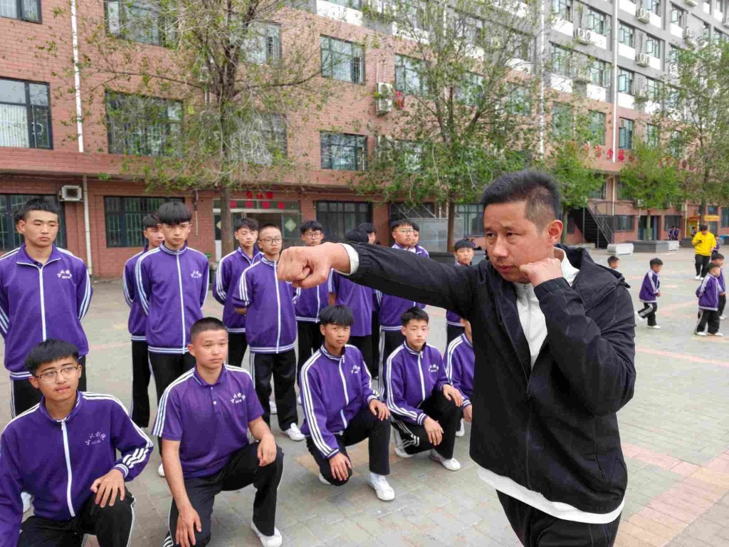 image shows shaolin kung fu coach wu peng teaching how to punch