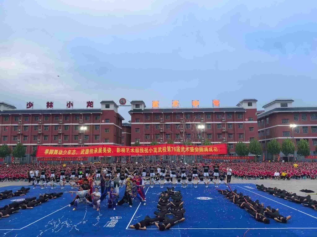image shows disciples performing at shaolin kung fu school at evening