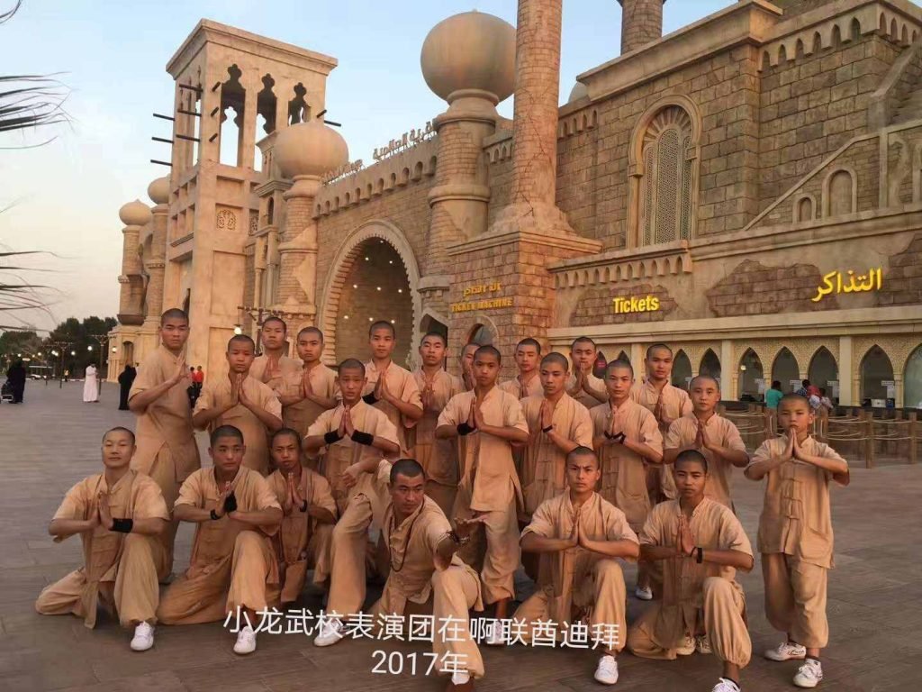 image shows students standing in Khaki uniform