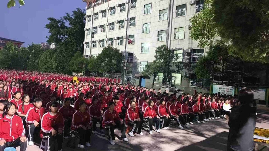 the image shows students learning about the legacy of Shaolin Xiaolong Academy