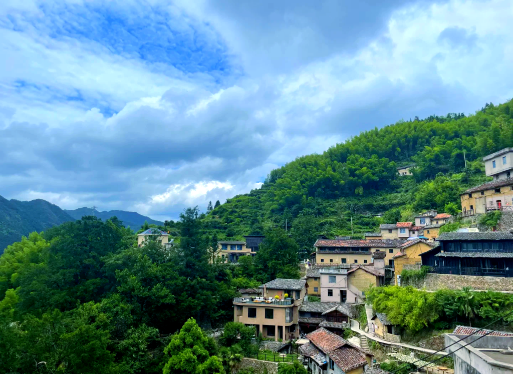 Traditional earthen village houses on a lush hillside, reflecting the heritage of the northern wei dynasty.