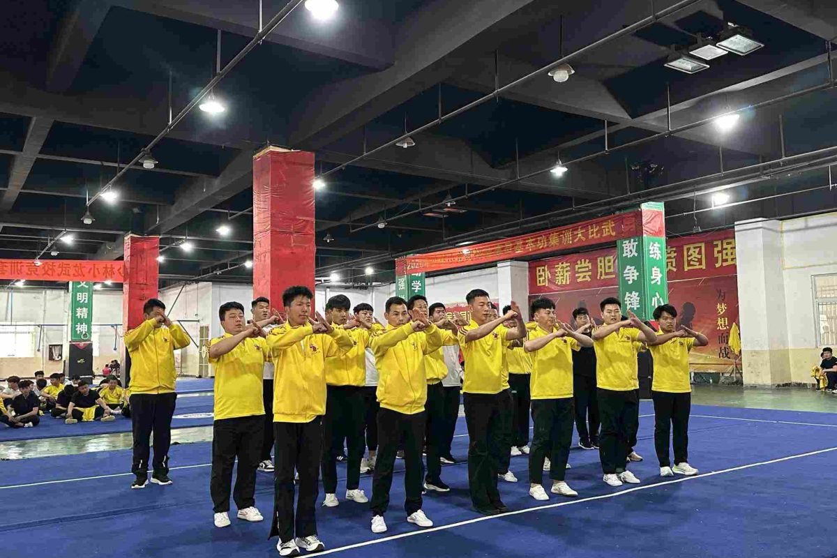 Dedicated practitioners perform a traditional respectful salute to begin their disciplined Shaolin daily routine.